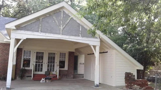 The finished exterior showing the gable end with curved brackets.
