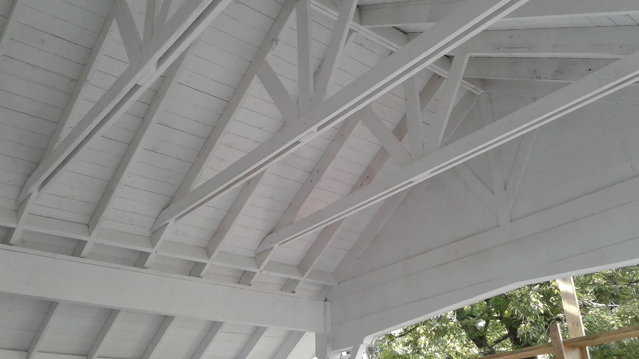 The painted rafter ties and roof structure seen from beneath.