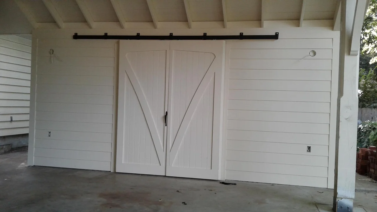 The finished interior with the white sliding doors built for the carport.