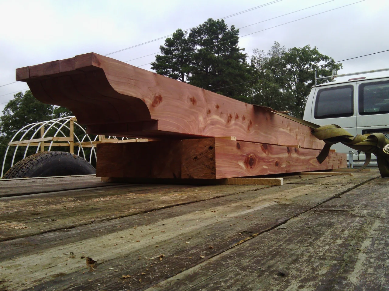 A large shaped beam with an ogee end resting at the sawmill.
