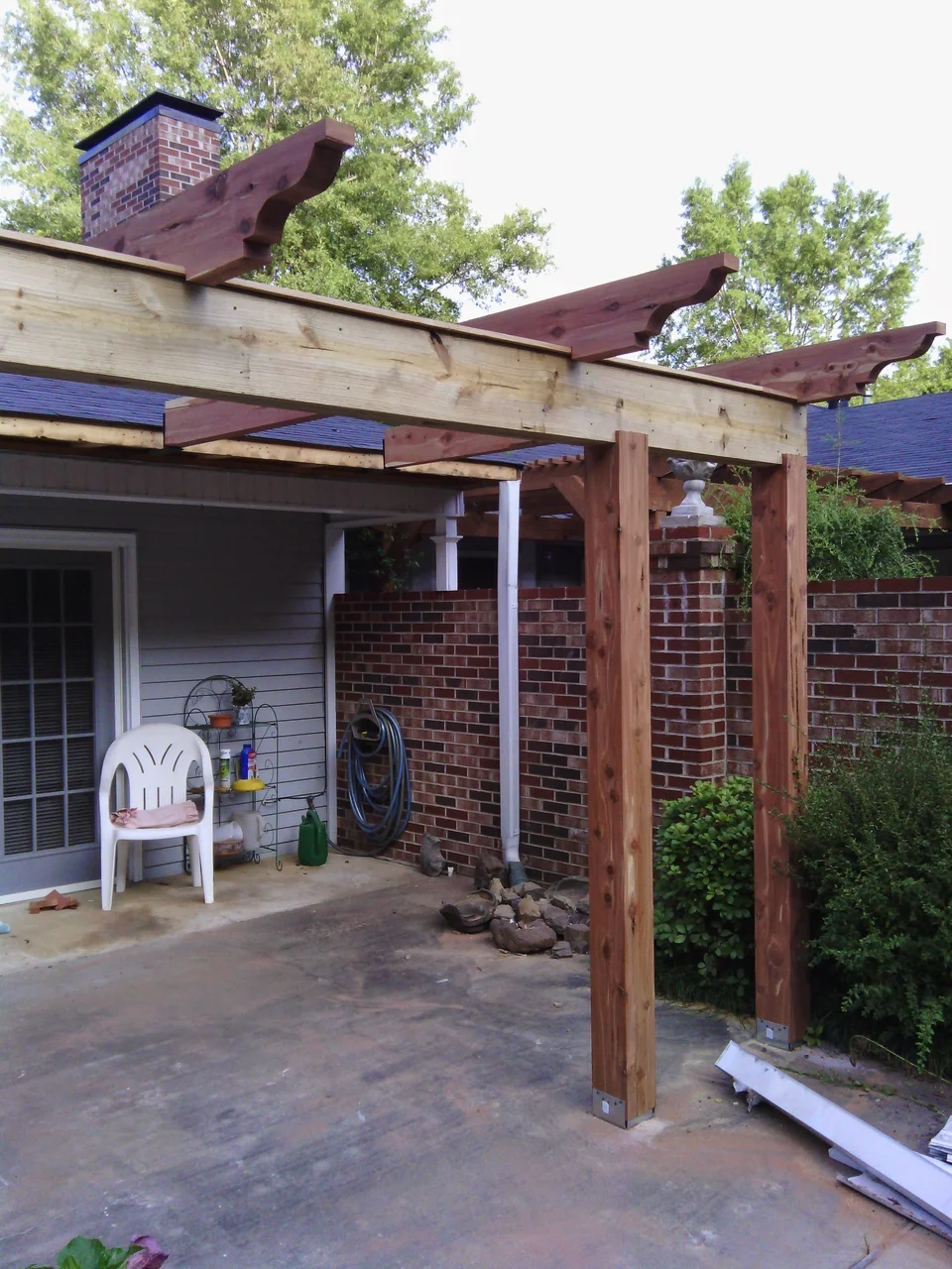 Pergola posts installed and standing at the patio.