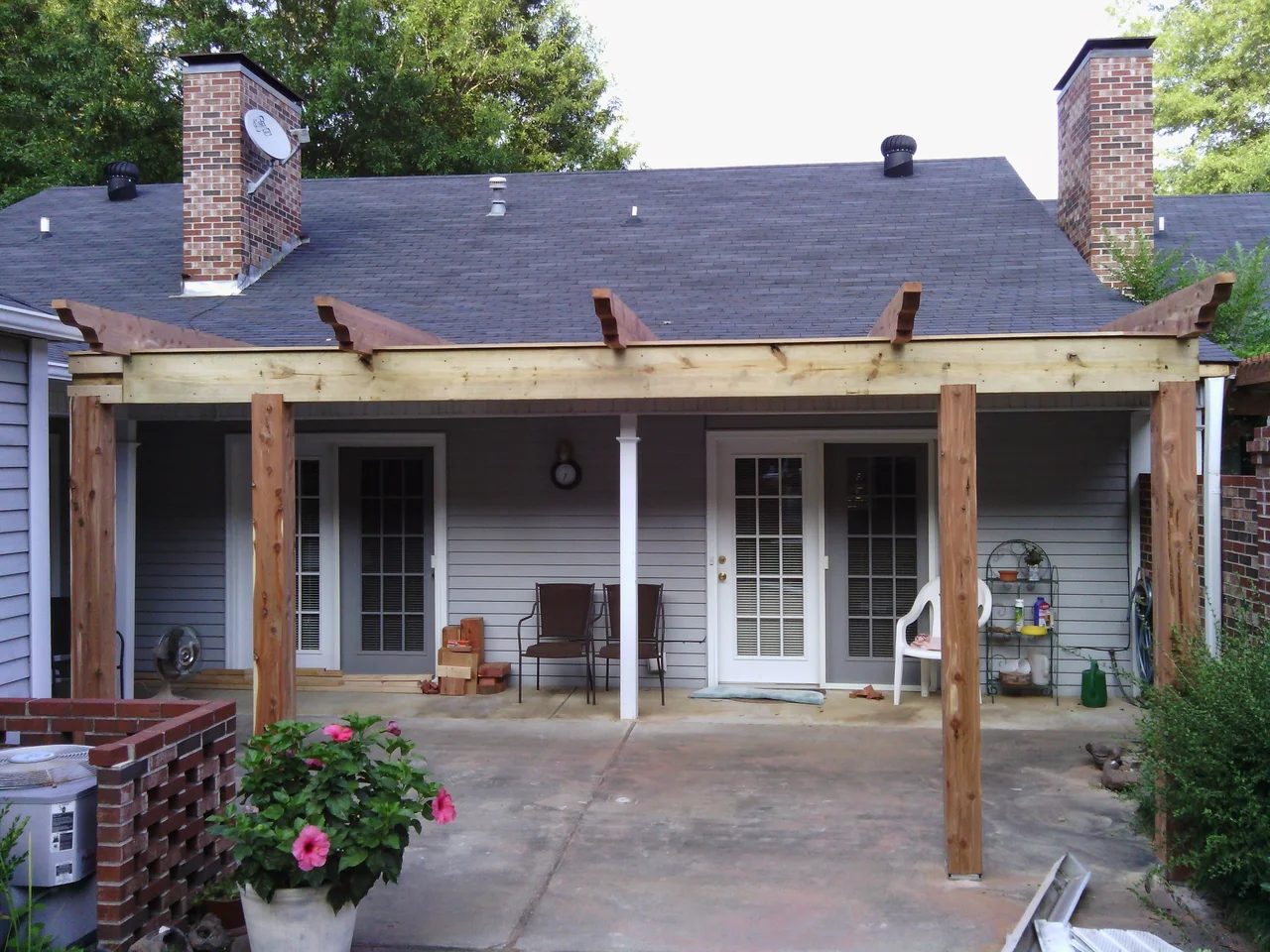 Wide view of the pergola frame set against the house.