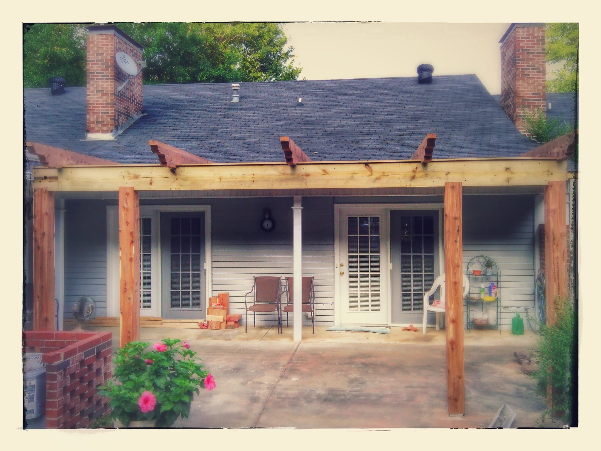 The pergola carried on timber posts along the back of the house.